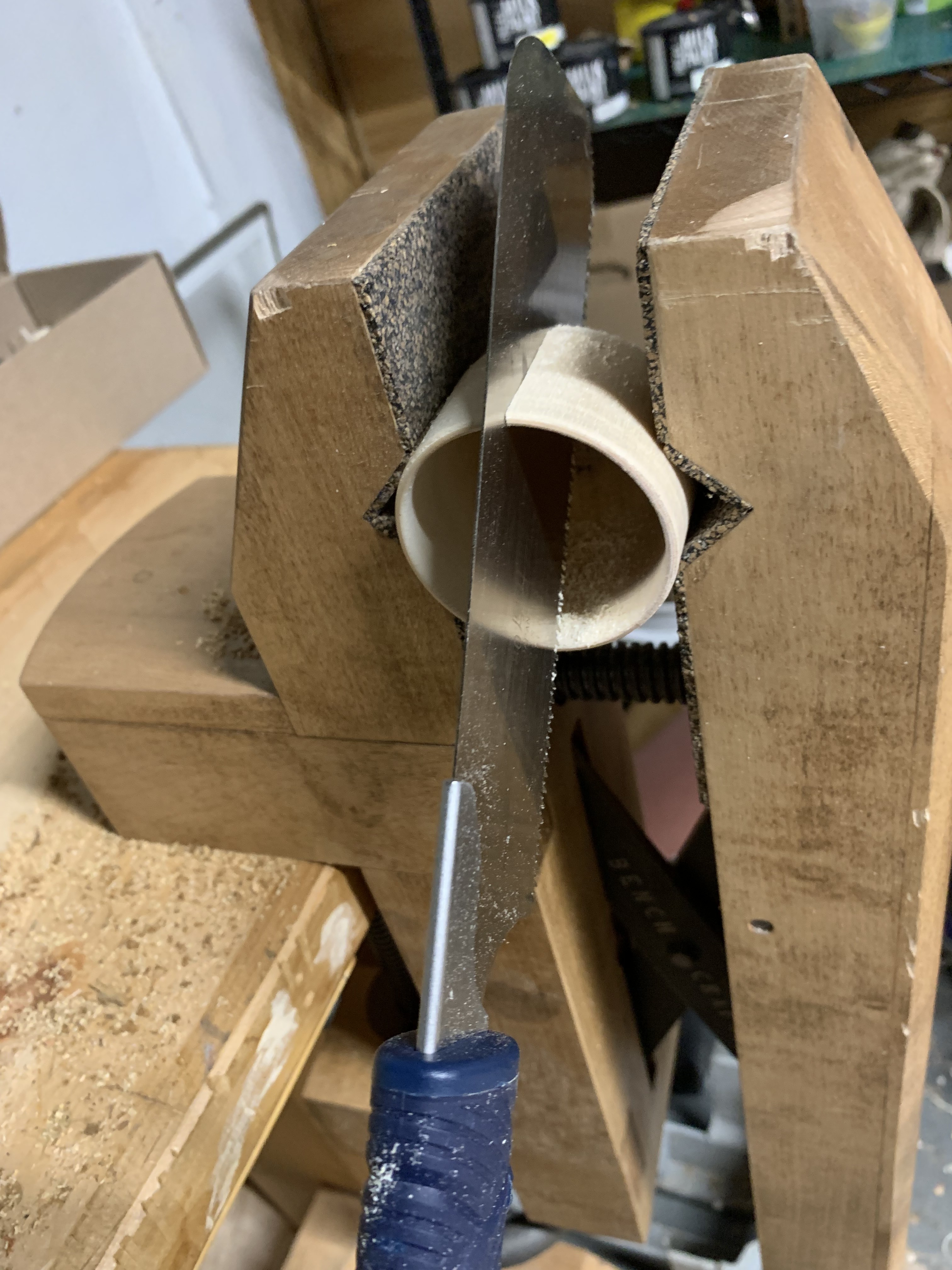 A saw cuts a wooden cup in half